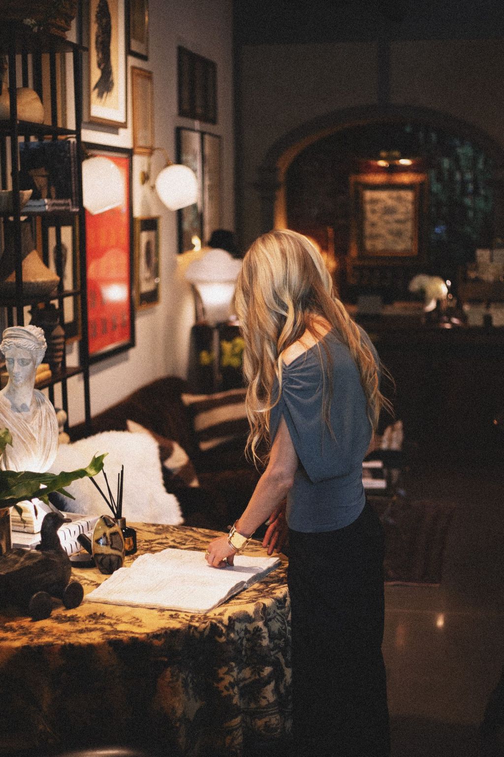 Interior of a Greenville, South Carolina, boutique shop with vintage decor and a woman reviewing documents